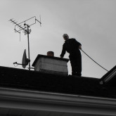 Chimney Sweep On The Roof